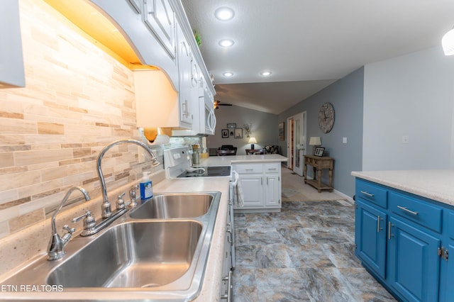 kitchen featuring range with electric cooktop, blue cabinets, ceiling fan, sink, and white cabinets