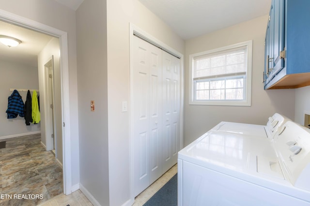 laundry area with cabinets and washing machine and clothes dryer