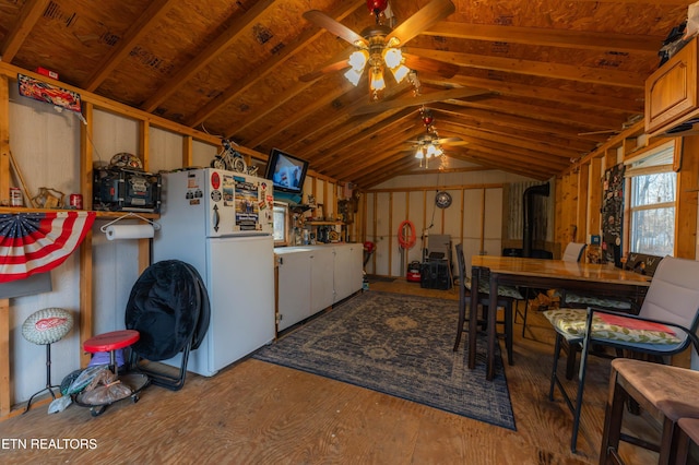 interior space featuring ceiling fan, hardwood / wood-style floors, lofted ceiling, and white refrigerator