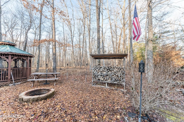 view of yard featuring a gazebo and an outdoor fire pit