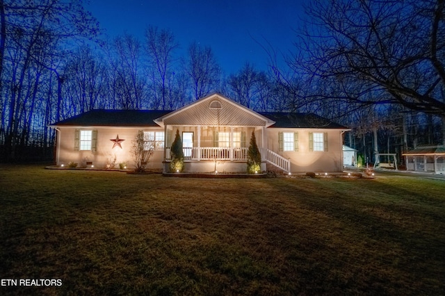 single story home with a lawn and covered porch