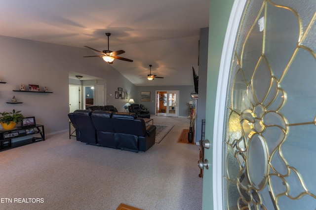 carpeted living room featuring ceiling fan and vaulted ceiling