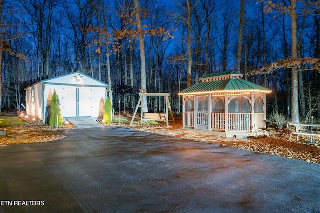 exterior space with a gazebo and an outbuilding