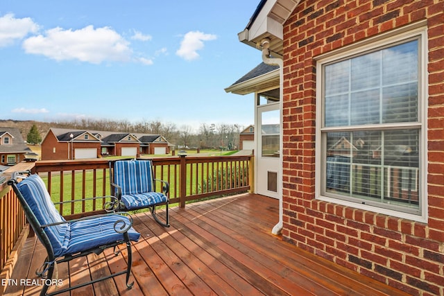 wooden terrace featuring a yard