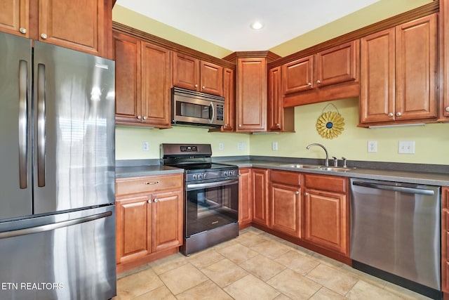 kitchen featuring sink, light tile patterned floors, and stainless steel appliances