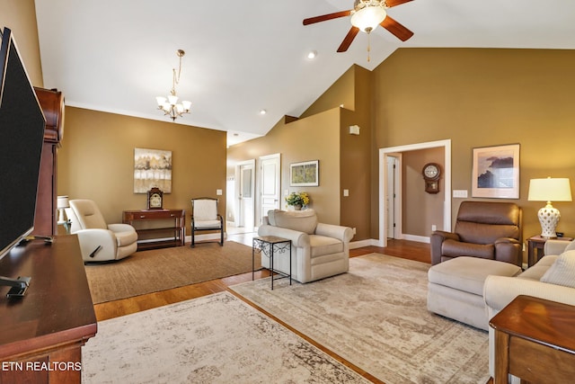 living room with ceiling fan with notable chandelier, wood-type flooring, and high vaulted ceiling