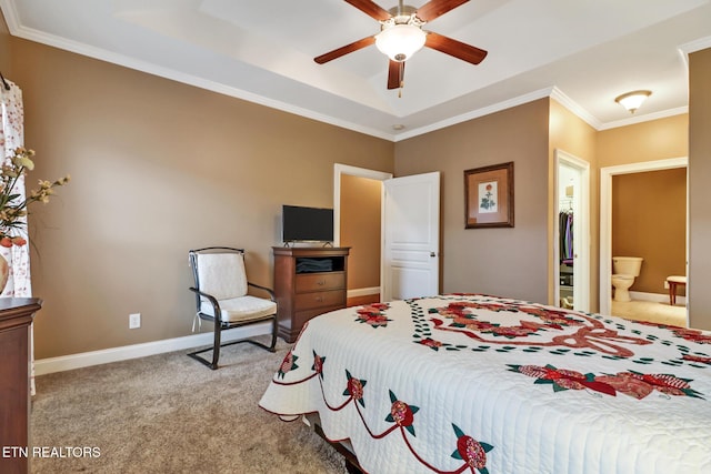 bedroom with light carpet, ornamental molding, a raised ceiling, ceiling fan, and connected bathroom