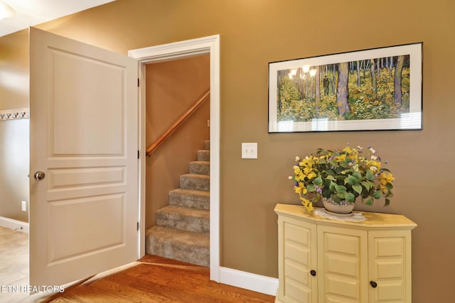 stairs featuring hardwood / wood-style floors