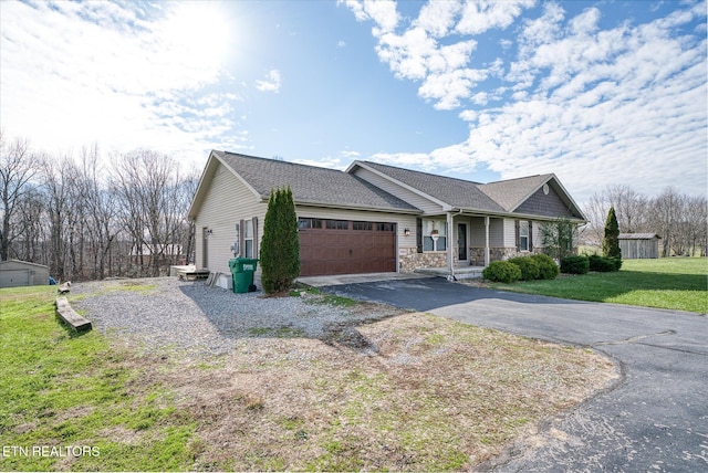 view of front of house featuring a garage and a front lawn