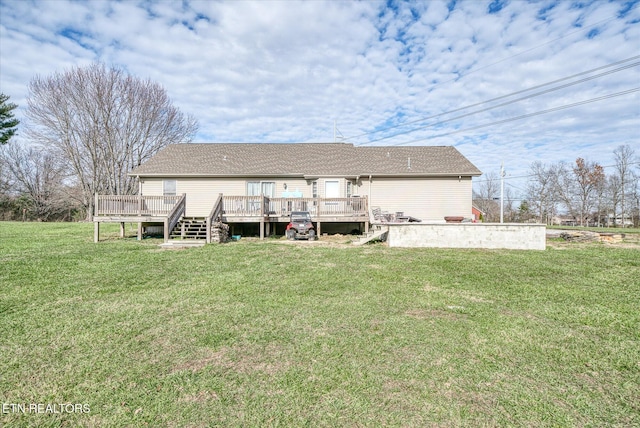 rear view of property with a lawn and a deck