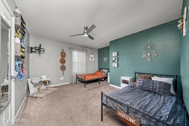 bedroom featuring ceiling fan, carpet floors, and a textured ceiling