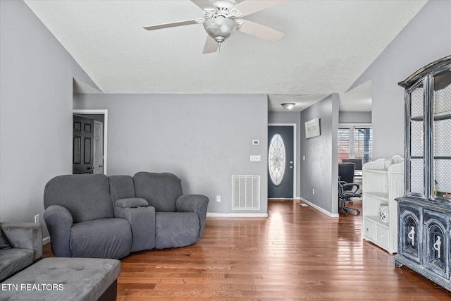 living room with vaulted ceiling, ceiling fan, and hardwood / wood-style floors