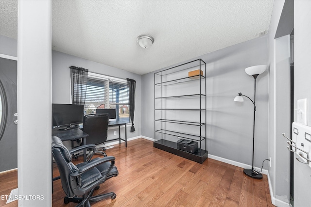 office area featuring hardwood / wood-style floors and a textured ceiling