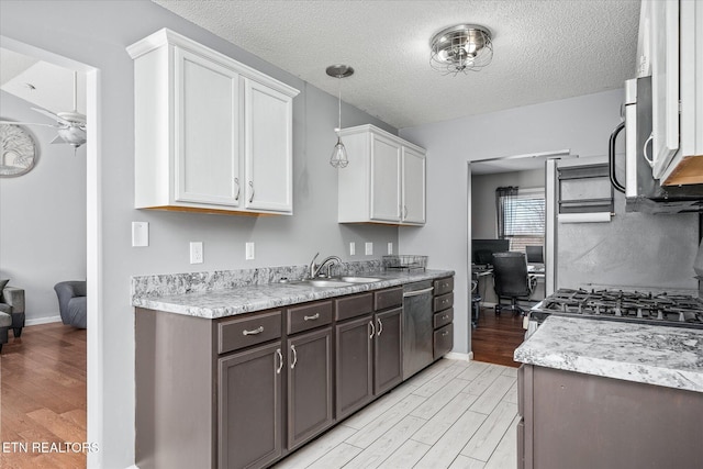 kitchen featuring white cabinetry, appliances with stainless steel finishes, dark brown cabinetry, and light hardwood / wood-style floors