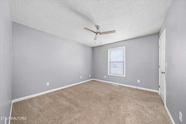 spare room with ceiling fan, carpet, and a textured ceiling