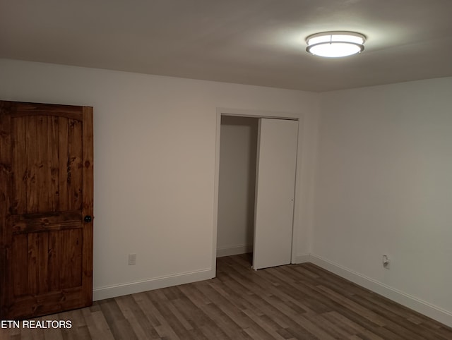 unfurnished bedroom featuring hardwood / wood-style floors and a closet