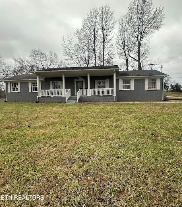 ranch-style house with a front yard and a porch