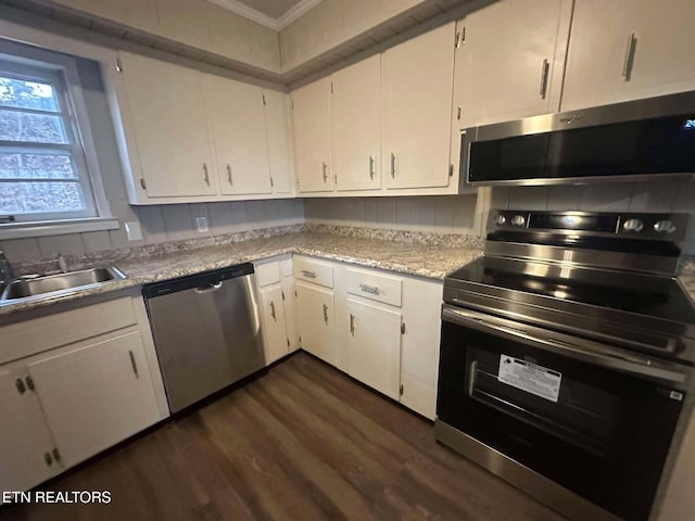 kitchen featuring dark hardwood / wood-style flooring, white cabinets, stainless steel appliances, and sink