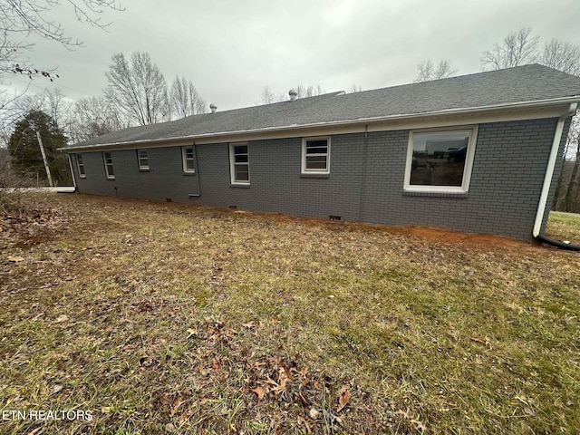 view of side of home featuring a lawn