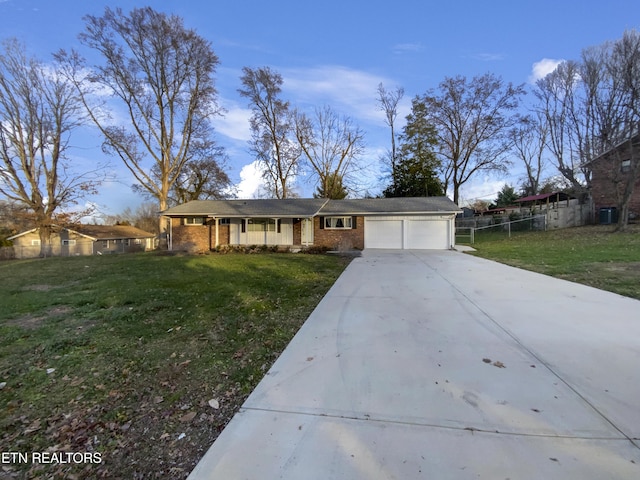 ranch-style house featuring a garage and a front yard