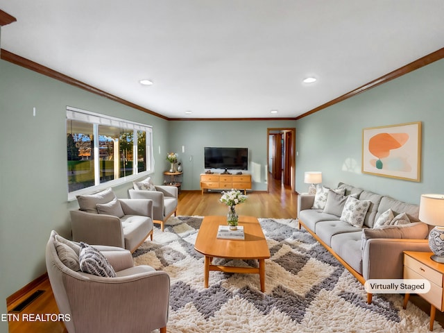 living room with crown molding and light wood-type flooring