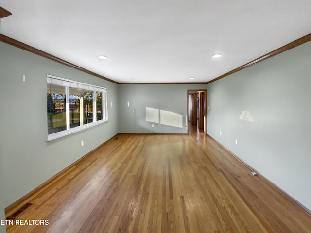 unfurnished living room with light hardwood / wood-style flooring and ornamental molding