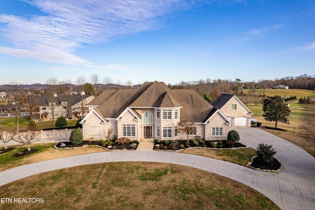 view of front of house featuring a garage and a front lawn