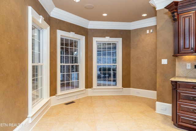 unfurnished dining area featuring ornamental molding