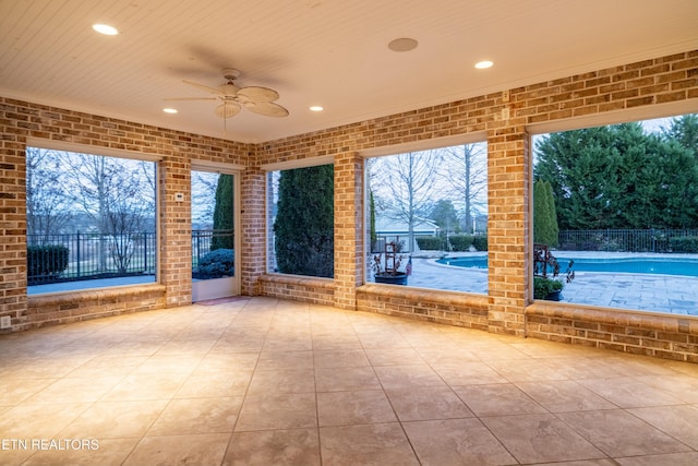 view of patio / terrace featuring ceiling fan and a swimming pool