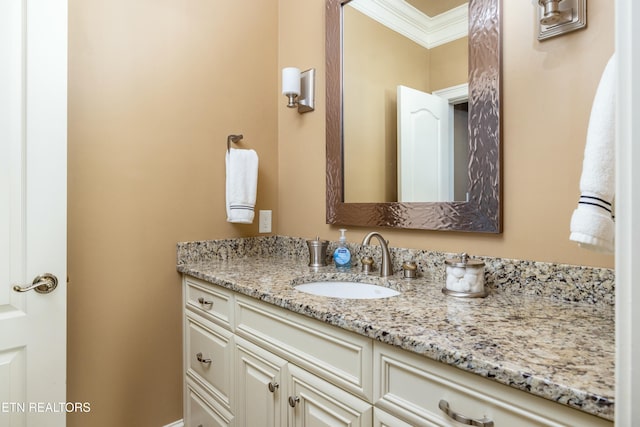 bathroom featuring crown molding and vanity