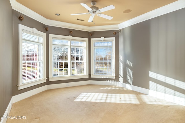 carpeted spare room featuring ceiling fan and ornamental molding