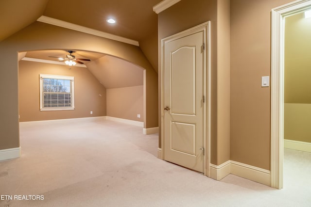 additional living space featuring ceiling fan, light colored carpet, and vaulted ceiling