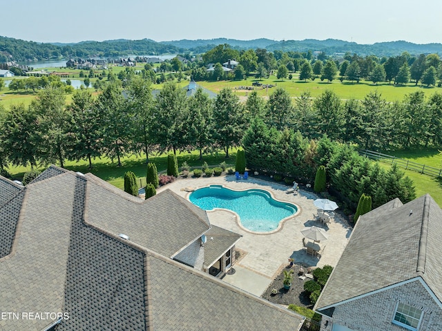 view of pool featuring a mountain view and a patio