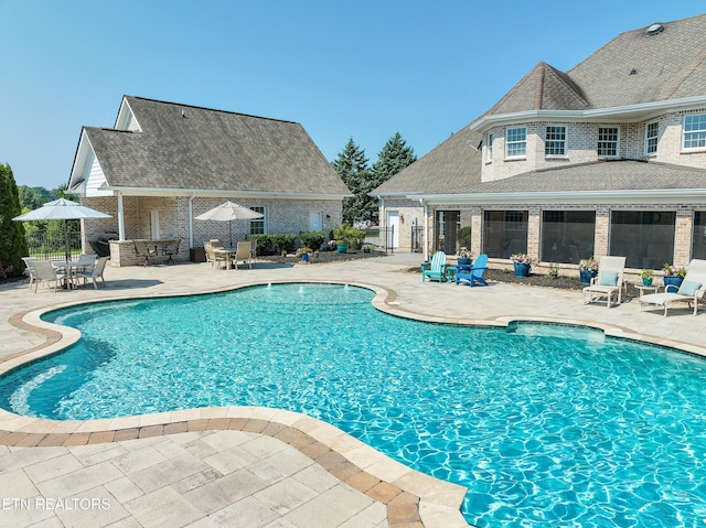 view of swimming pool with a patio