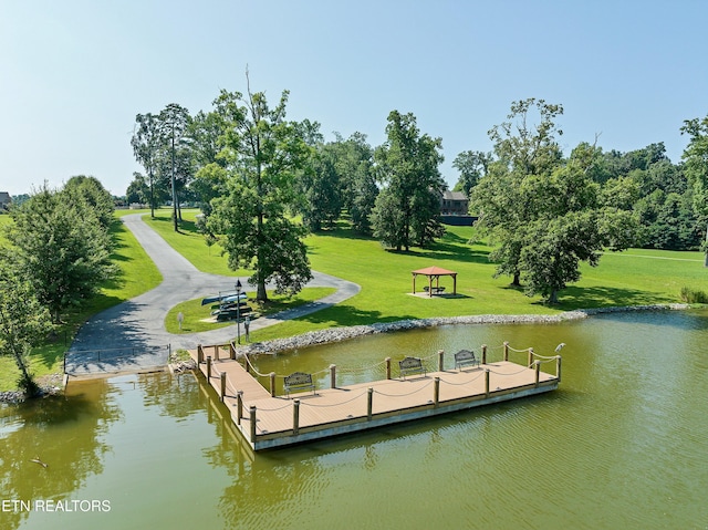 dock area featuring a water view and a yard