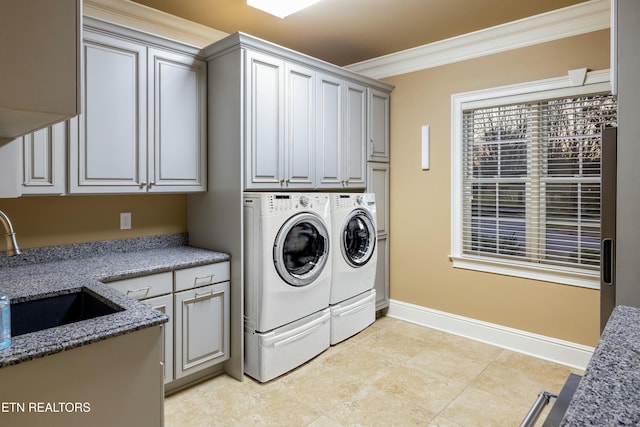 laundry room featuring sink, cabinets, washing machine and dryer, light tile patterned flooring, and ornamental molding