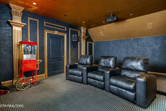 home theater with carpet flooring, decorative columns, and vaulted ceiling