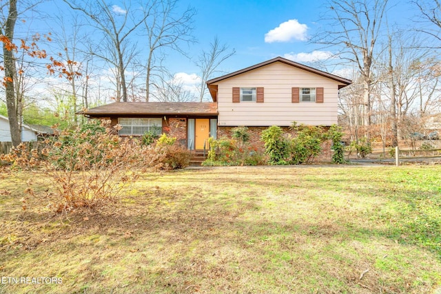 tri-level home with a front lawn