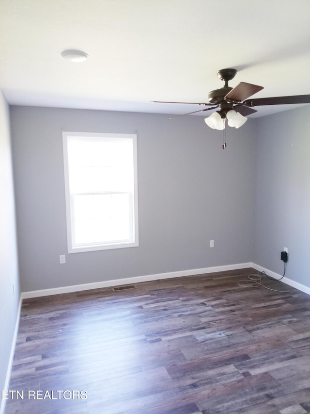 spare room with ceiling fan and dark hardwood / wood-style flooring