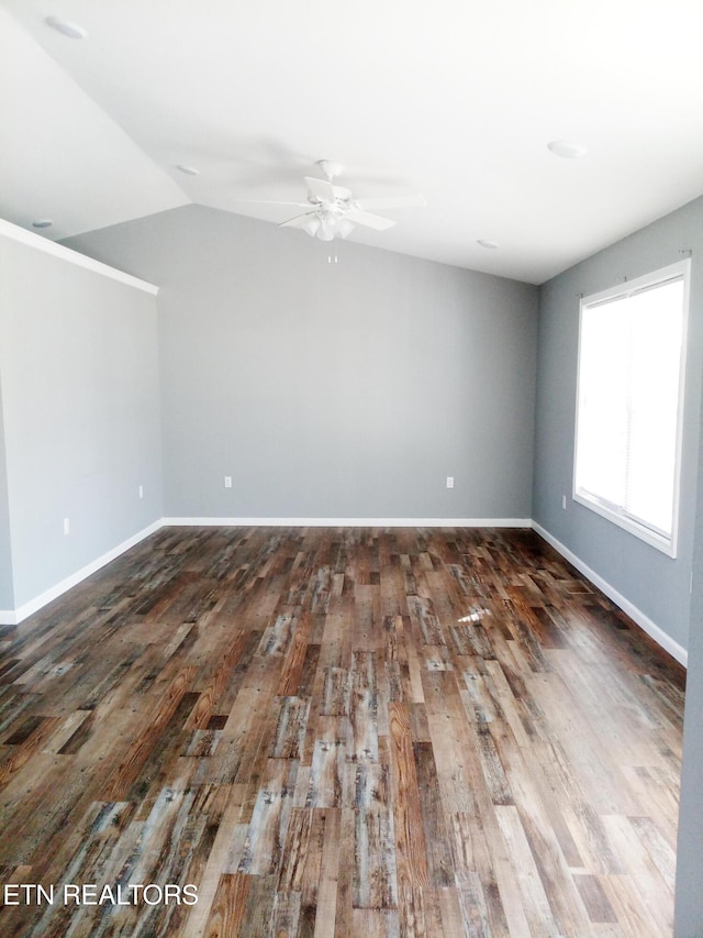 unfurnished room with ceiling fan, dark wood-type flooring, and lofted ceiling