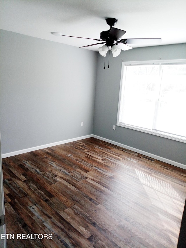 empty room featuring ceiling fan and dark hardwood / wood-style floors