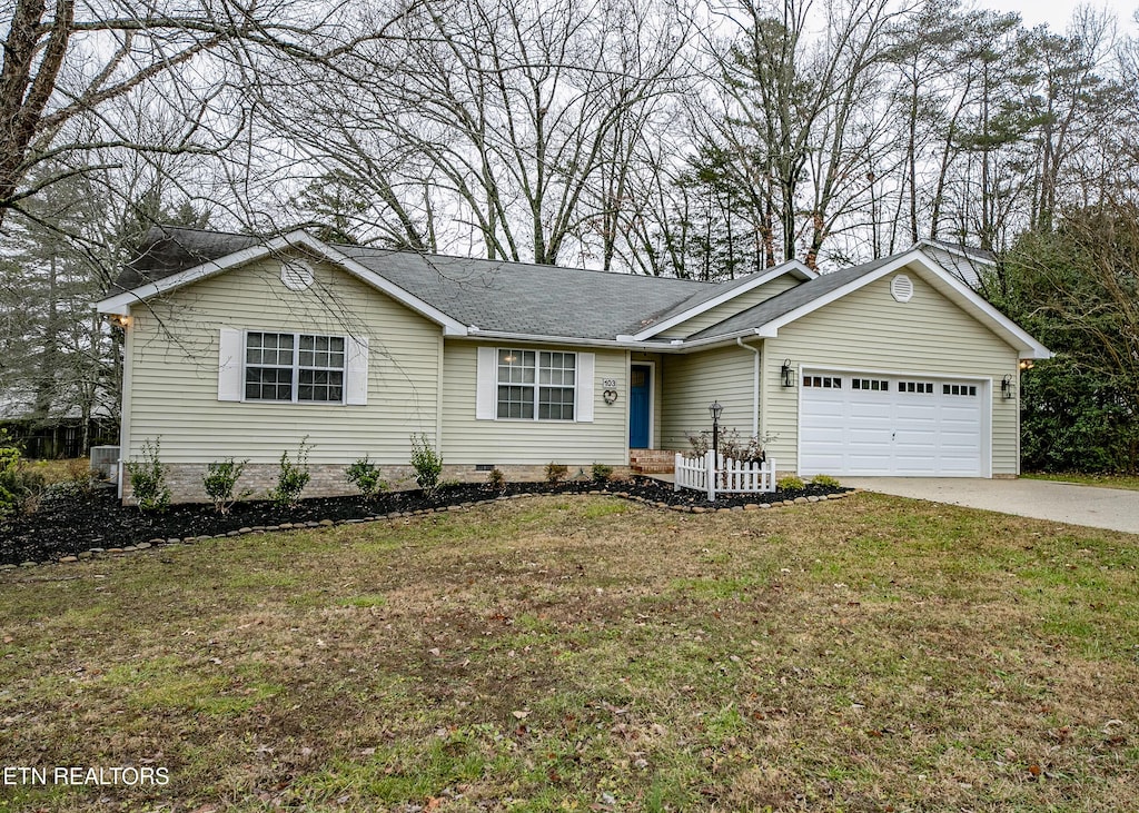 single story home featuring a garage and a front lawn