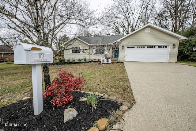 view of front of house featuring a garage and a front lawn