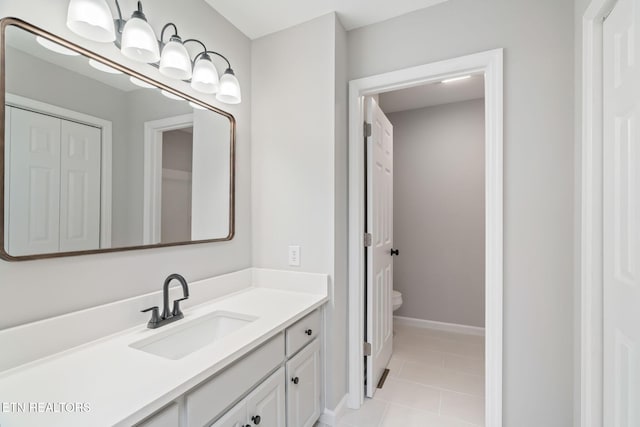 bathroom featuring tile patterned floors, vanity, and toilet