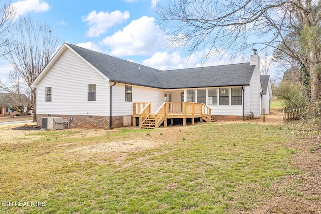 rear view of property with central AC, a deck, and a lawn
