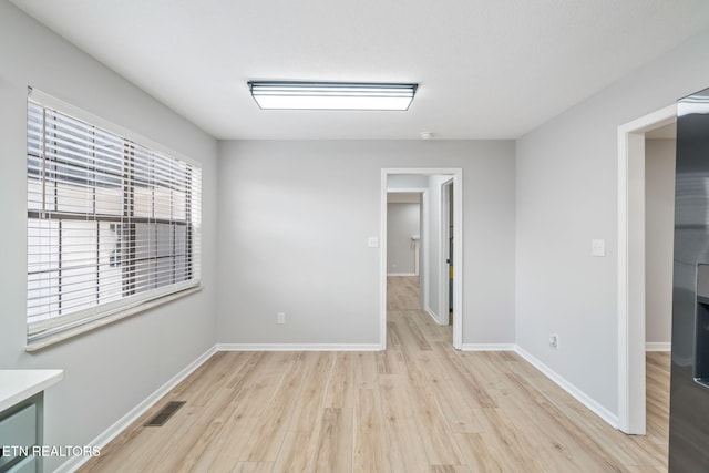 unfurnished room featuring light wood-type flooring