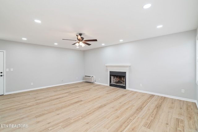 unfurnished living room with ceiling fan and light hardwood / wood-style flooring