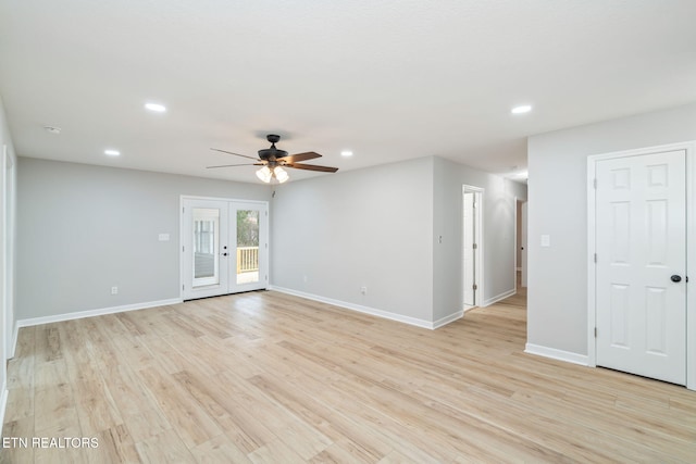 spare room featuring french doors, light wood-type flooring, and ceiling fan