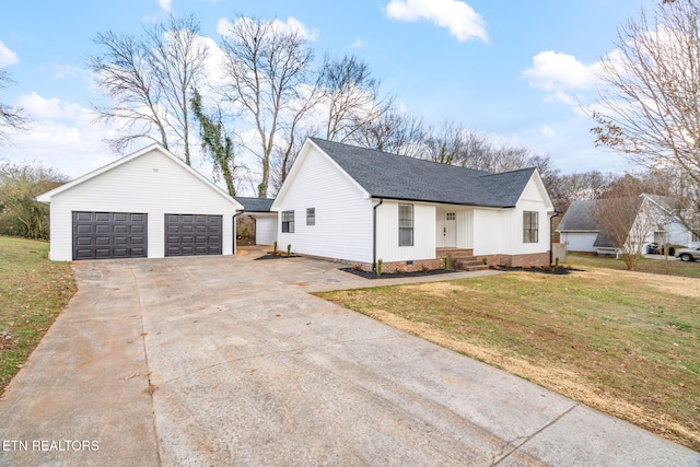 modern farmhouse with a garage, a front lawn, and an outdoor structure