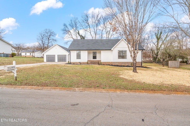 view of front of property with a garage and a front lawn